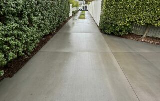 Concrete driveway surface restored and brightened after professional acid wash cleaning.
