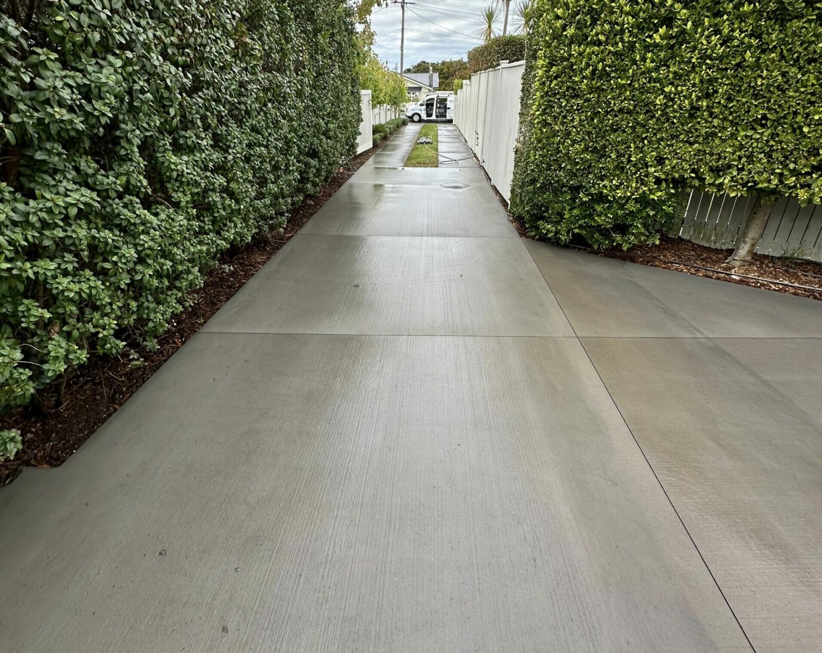 Concrete driveway surface restored and brightened after professional acid wash cleaning.