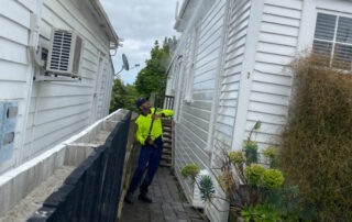 Metro Water Blasting technician performing soft washing on a house exterior to remove dirt, mold, and grime.