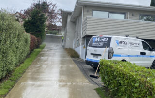 Gutter completely clogged with thick layers of wet leaves, sticks, and organic debris before cleaning.