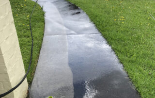Concrete pathway restored to a clean, bright surface after professional water blasting service.